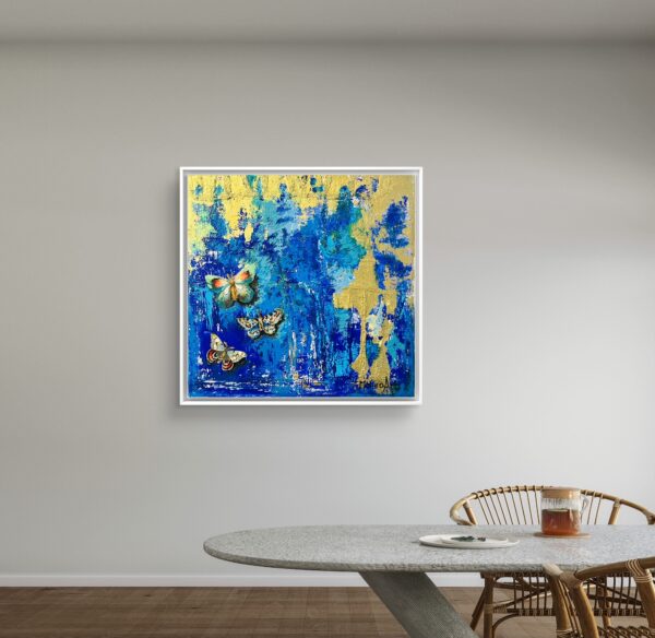 Butterfly painting hanging next to table
